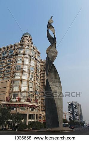 Stock Photo - A Building And Sculpture Against A Blue Sky; Tianjin China. Fotosearch