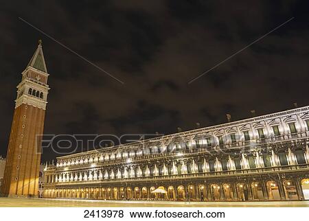 Stock Photo - A building illuminated at nighttime in Piazzo San Marco; Venice, Veneto, Italy. Fotosearch