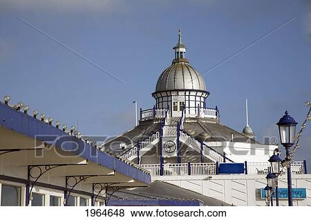 Stock Photo - A Building With A Domed Building And Clock Along The Pier; Eastbourne Sussex England. Fotosearch