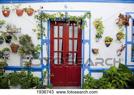 A Building With A Red Door And Flower Pots Attached To The Outside Wall In The Old Castle; Castellar De La Frontera Andalusia Spain View Large Photo Image Stock Image - A Building With A Red Door And Flower Pots Attached To The Outside Wall In The Old Castle; Castellar De La Frontera Andalusia Spain. Fotosearch