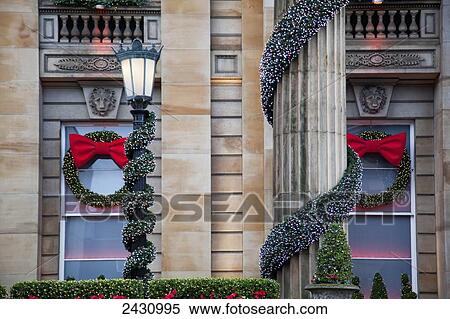 Stock Photography - A building with columns decorated with garland and wreaths at Christmas; Edinburgh, Scotland. Fotosearch
