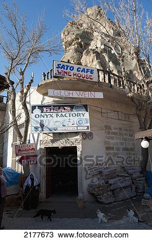 A Building With Numerous Signs On The Corner And Cats Sitting Out Front; Ortahisar Nevsehir Turkey View Large Photo Image Stock Image - A Building With Numerous Signs On The Corner And Cats Sitting Out Front; Ortahisar Nevsehir Turkey. Fotosearch