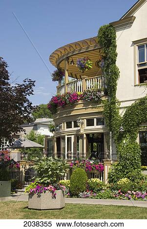 A Building With Vines And Flower Pots; Niagara On The Lake Ontario Canada View Large Photo Image Stock Photography - A Building With Vines And Flower Pots; Niagara On The Lake Ontario Canada. Fotosearch