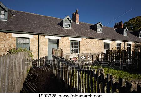 Stock Photo - A Building With Windows And A Wooden Picket Fence; Beamish, Durham, England. Fotosearch