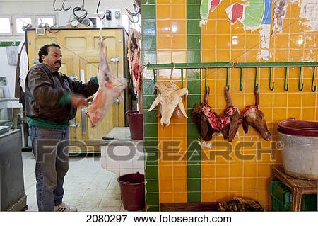 A Butcher Carves A Sheep Carcass In The Souk; Sfax, Tunisia, North Africa View Large Photo Image Stock Photo - A Butcher Carves A Sheep Carcass In The Souk; Sfax, Tunisia, North Africa. Fotosearch