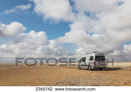 A Camper Van Is Parked In An Oklahoma Panhandle Wheat Field With Dramatic White Clouds And Blue Sky Near Highway 56 Northeast Of Boise City; Oklahoma, United States Of America View Large Photo Image Stock Image - A Camper Van Is Parked In An Oklahoma Panhandle Wheat Field With Dramatic White Clouds And Blue Sky Near Highway 56 Northeast Of Boise City; Oklahoma, United States Of America. Fotosearch