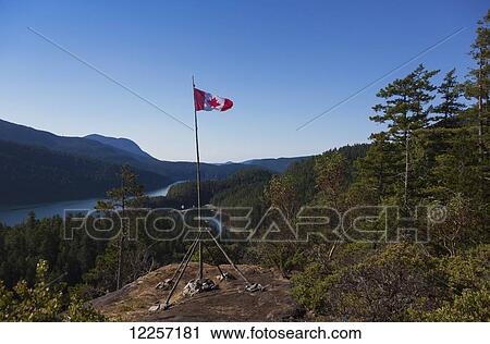 A Canadian flag pole on top of a mountain in Desolation Sound; British Columbia, Canada View Large Photo Image Stock Image - A Canadian flag pole on top of a mountain in Desolation Sound; British Columbia, Canada. Fotosearch