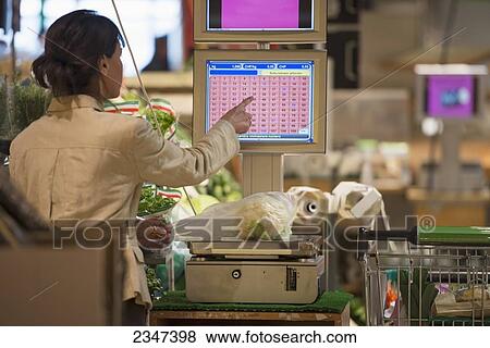 A Cashier Weighs Fresh Produce On A Scale And Chooses A Button On The Screen At Checkout; Ascona, Ticino, Switzerland View Large Photo Image Stock Photo - A Cashier Weighs Fresh Produce On A Scale And Chooses A Button On The Screen At Checkout; Ascona, Ticino, Switzerland. Fotosearch