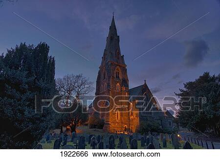 Stock Photograph - A Cemetery And Church Building Illuminated; Ambleside, Cumbria, England. Fotosearch