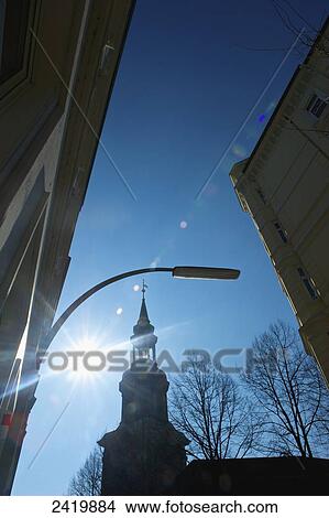 A church tower with a sun flare in a blue sky; Hamburg, Germany View Large Photo Image Picture - A church tower with a sun flare in a blue sky; Hamburg, Germany. Fotosearch