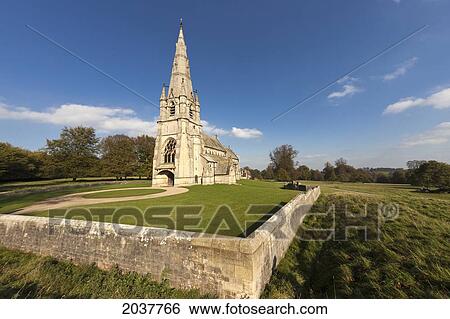 Stock Photograph - A Church With A Steeple And Stone Fence; Studley North Yorkshire England. Fotosearch