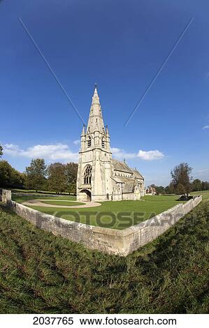 Stock Photography - A Church With A Steeple And Stone Fence; Studley North Yorkshire England. Fotosearch