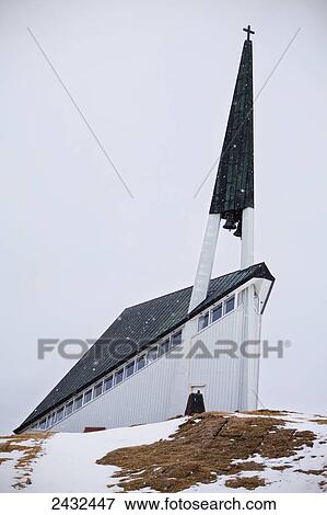 Stock Photo - A church with tall steeple and cross; Mosfellsdalur, Iceland. Fotosearch