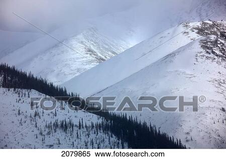 Stock Photography - A Clearing In A Winter Storm In The Mountains Along The Dempster Highway, Yukon.. Fotosearch