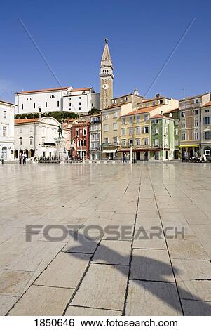 A Clock Tower Amidst Buildings In A City View Large Photo Image Stock Photograph - A Clock Tower Amidst Buildings In A City. Fotosearch