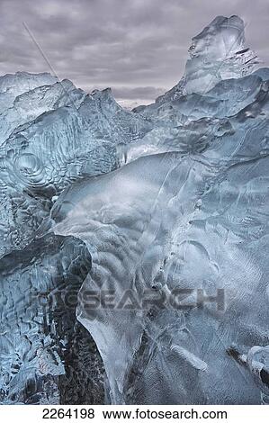Stock Photo - A close-up view of glacial ice strewn across a coastal beach; iceland. Fotosearch