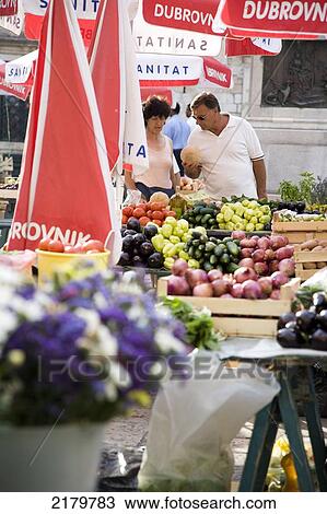 Stock Image - A Couple Buying Fruit In A Market Dubrovnik, Croatia. Fotosearch