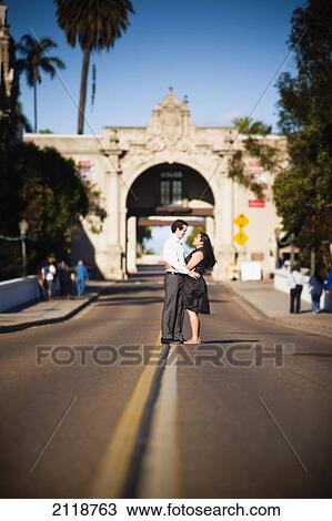 A Couple Hugs In The Middle Of The Road At Balboa Park; San Diego California Usa View Large Photo Image Stock Image - A Couple Hugs In The Middle Of The Road At Balboa Park; San Diego California Usa. Fotosearch