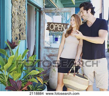 Picture - A couple looking at souvenirs; Kapaa, Kauai, Hawaii, United States of America. Fotosearch