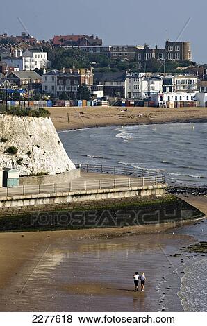 Stock Photo - A couple of joggers along Louisa Bay with Viking Bay in the distance; Broadstairs, Kent, England. Fotosearch