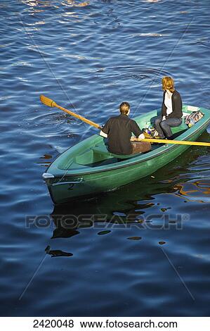 A couple paddling in a canoe on the river; Hamburg, Germany View Large Photo Image Stock Photo - A couple paddling in a canoe on the river; Hamburg, Germany. Fotosearch