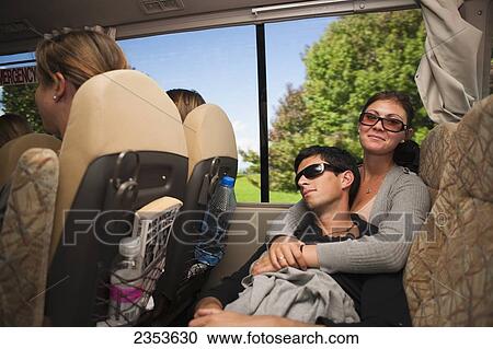 Stock Image - A Couple Relaxes On A Long Bus Journey From Wellington To Auckland; New Zealand. Fotosearch