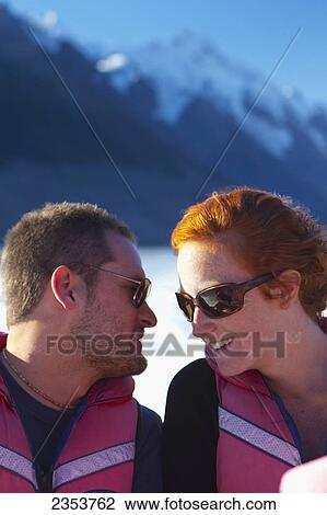 A Couple Shares A Moment As They Take A Boat Trip Through A Lake At The Base Of Mount Cook; New Zealand View Large Photo Image Stock Image - A Couple Shares A Moment As They Take A Boat Trip Through A Lake At The Base Of Mount Cook; New Zealand. Fotosearch