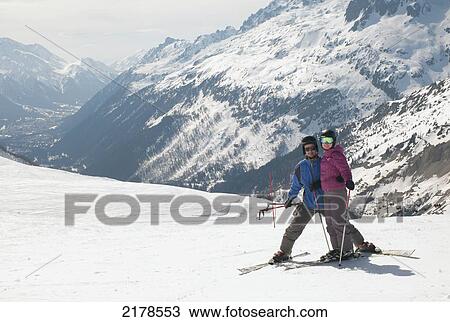 Stock Image - A Couple Skiing In The French Alps; Chaminox-Mont-Blanc Rhone-Alpes France. Fotosearch