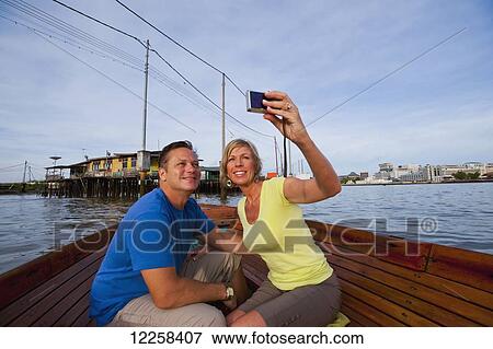 Stock Photo - A couple taking a river boat ride; Bandar Seri Begawan, Brunei. Fotosearch