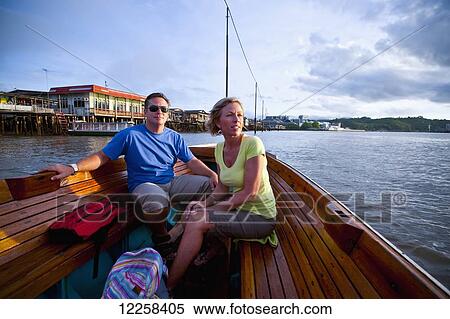 Stock Photography - A couple taking a river boat ride; Bandar Seri Begawan, Brunei. Fotosearch