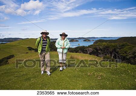 A Couple Walking On Urupukapuka Island, An Island In The Bay Of Islands; Urupukapuka Island, New Zealand View Large Photo Image Stock Photography - A Couple Walking On Urupukapuka Island, An Island In The Bay Of Islands; Urupukapuka Island, New Zealand. Fotosearch