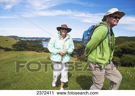 A Couple Walks On Urupukapuka Island; Bay Of Islands, New Zealand View Large Photo Image Stock Image - A Couple Walks On Urupukapuka Island; Bay Of Islands, New Zealand. Fotosearch