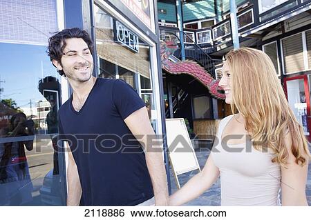 A couple walks together outside retail shops; Kapaa, Kauai, Hawaii, United States of America View Large Photo Image Stock Photograph - A couple walks together outside retail shops; Kapaa, Kauai, Hawaii, United States of America. Fotosearch