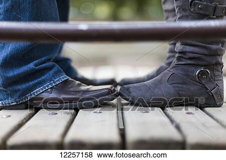 A couple wearing boots standing toe to toe; Vancouver, British Columbia, Canada View Large Photo Image Stock Photo - A couple wearing boots standing toe to toe; Vancouver, British Columbia, Canada. Fotosearch