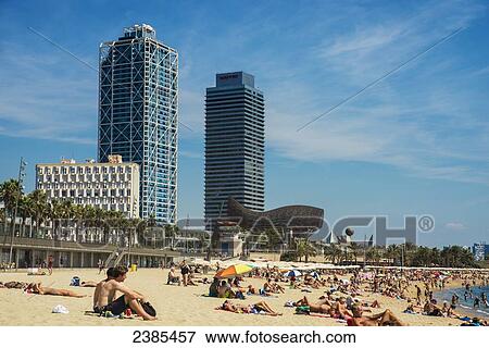 A crowded Barceloneta beach with skyscrapers in the distance; Barcelona, Catalonia, Spain View Large Photo Image Stock Photo - A crowded Barceloneta beach with skyscrapers in the distance; Barcelona, Catalonia, Spain. Fotosearch