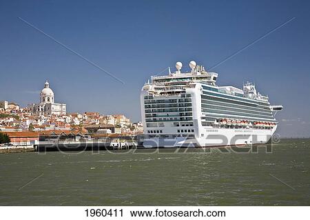 Stock Image - A Cruise Ship Moored With The Church Of Santa Engracia In The Background; Lisbon, Portugal. Fotosearch
