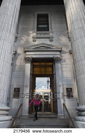 Stock Photograph - A Customer Walking Up The Steps To The Bank Of Montreal; Montreal Quebec Canada. Fotosearch