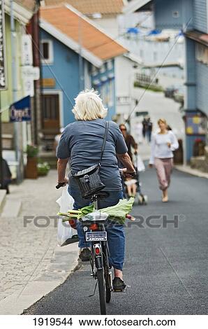 Picture - A Cyclist Travelling Through The Town Of Fjallbacka, Bohuslan, Bohuslan Islands, Sweden. Fotosearch