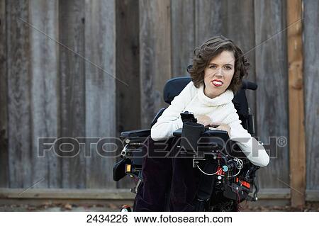 Stock Photograph - A disabled female sitting in her wheelchair; San Francisco, California, USA. Fotosearch
