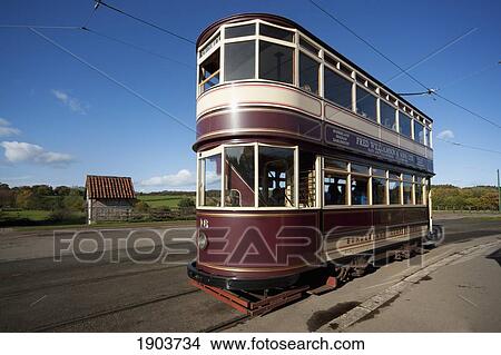 Picture - A Double Decker Rail Car Traveling On The Tracks; Beamish, Durham, England. Fotosearch