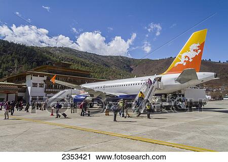 A Drukair Jet Plane Unloads Passengers At The Airport; Paro, Bhutan View Large Photo Image Stock Image - A Drukair Jet Plane Unloads Passengers At The Airport; Paro, Bhutan. Fotosearch