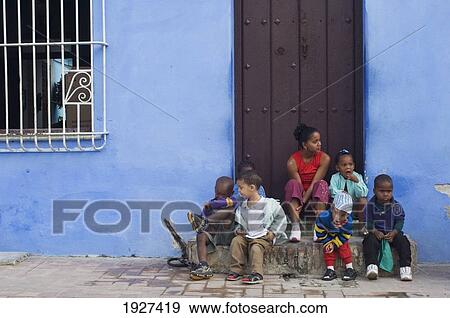 A Family Sitting Together On Their Doorstep, Camaguey, Cuba View Large Photo Image Stock Photo - A Family Sitting Together On Their Doorstep, Camaguey, Cuba. Fotosearch