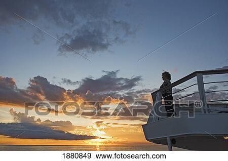 A Female Passenger On The Top Deck Of Cruise Ship Watching Sunset View Large Photo Image Stock Photo - A Female Passenger On The Top Deck Of Cruise Ship Watching Sunset. Fotosearch