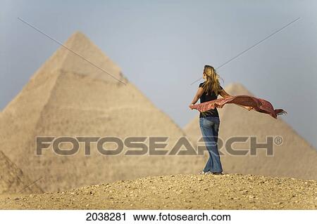 A Female Tourist Holds A Silk Scarf In The Wind As She Looks Out Toward The Pyramids Of Giza Near Cairo; Giza Egypt View Large Photo Image Stock Image - A Female Tourist Holds A Silk Scarf In The Wind As She Looks Out Toward The Pyramids Of Giza Near Cairo; Giza Egypt. Fotosearch