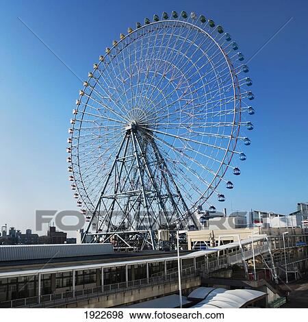 A Ferris Wheel Against A Blue Sky; Osaka, Japan View Large Photo Image Stock Photo - A Ferris Wheel Against A Blue Sky; Osaka, Japan. Fotosearch