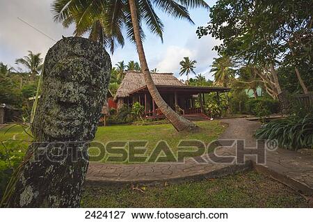 Stock Photo - A Fijian carving and the view of the dining area at Matava Resort; Island of Kadavu, Fiji. Fotosearch