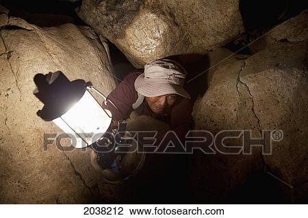 A Filipino Tour Guide Holds A Lantern Inside Sumaging Cave Or Big Cave Near Sagada; Luzon Philippines View Large Photo Image Stock Image - A Filipino Tour Guide Holds A Lantern Inside Sumaging Cave Or Big Cave Near Sagada; Luzon Philippines. Fotosearch