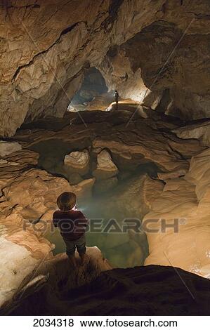 A Filipino Tour Guide Holds A Lantern Inside Sumaging Cave Or Big Cave Near Sagada; Luzon Philippines View Large Photo Image Stock Photo - A Filipino Tour Guide Holds A Lantern Inside Sumaging Cave Or Big Cave Near Sagada; Luzon Philippines. Fotosearch