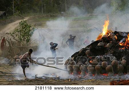 A fire burning items producing smoke, Potters Village; Madhya Pradesh, India View Large Photo Image Stock Photo - A fire burning items producing smoke, Potters Village; Madhya Pradesh, India. Fotosearch