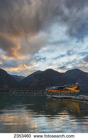 Stock Image - A Float Plane On Muncho Lake At Sunset; British Columbia, Canada. Fotosearch